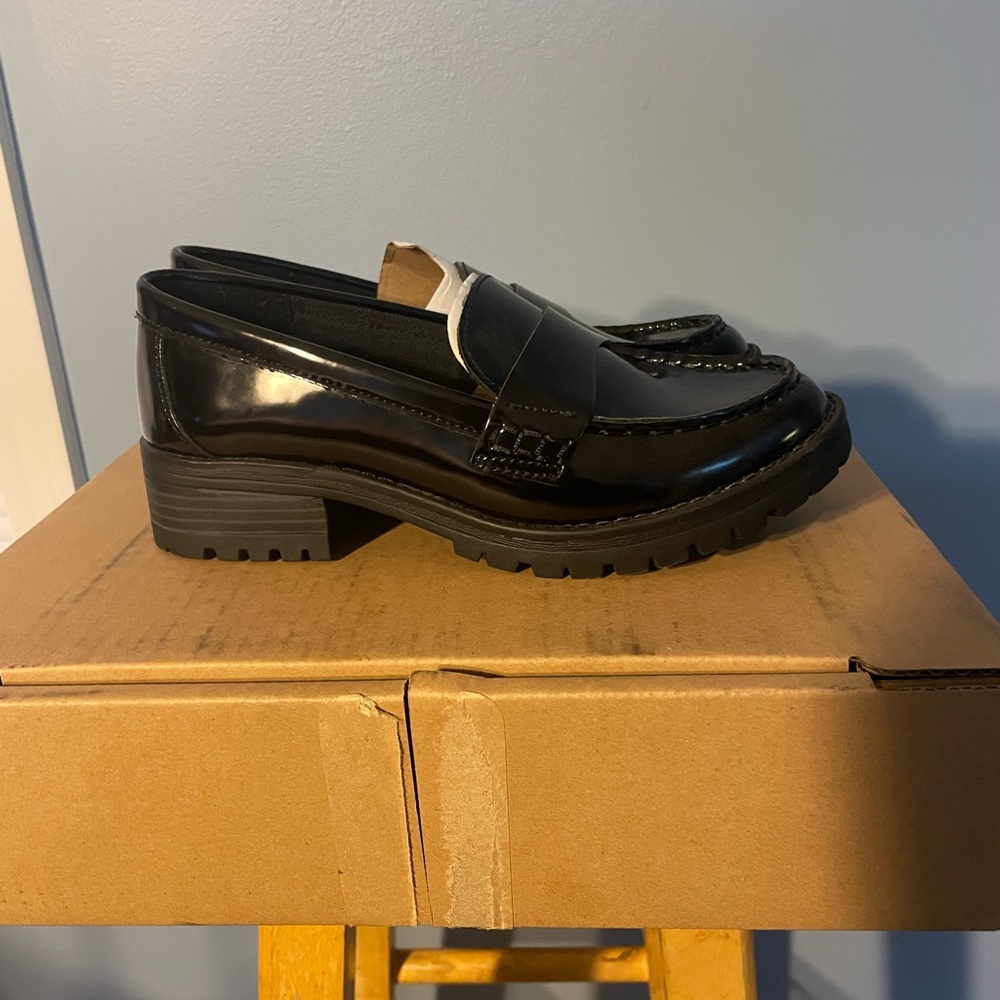 Faux leather black chunky heel loafer.